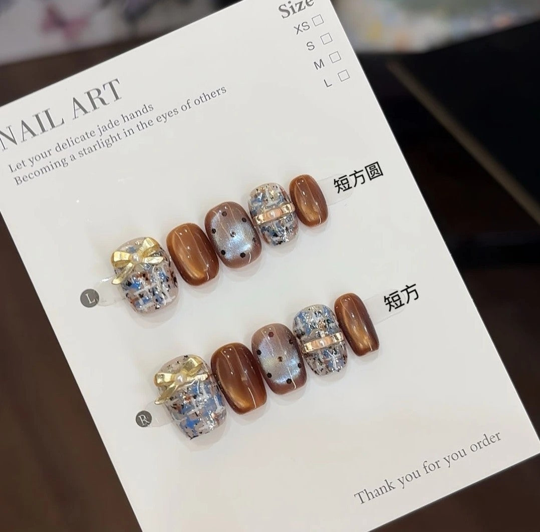 Handmade brown and blue Chanel-style high-end plaid short nails with bow, glass beads, and cat-eye effect for the new autumn and winter season